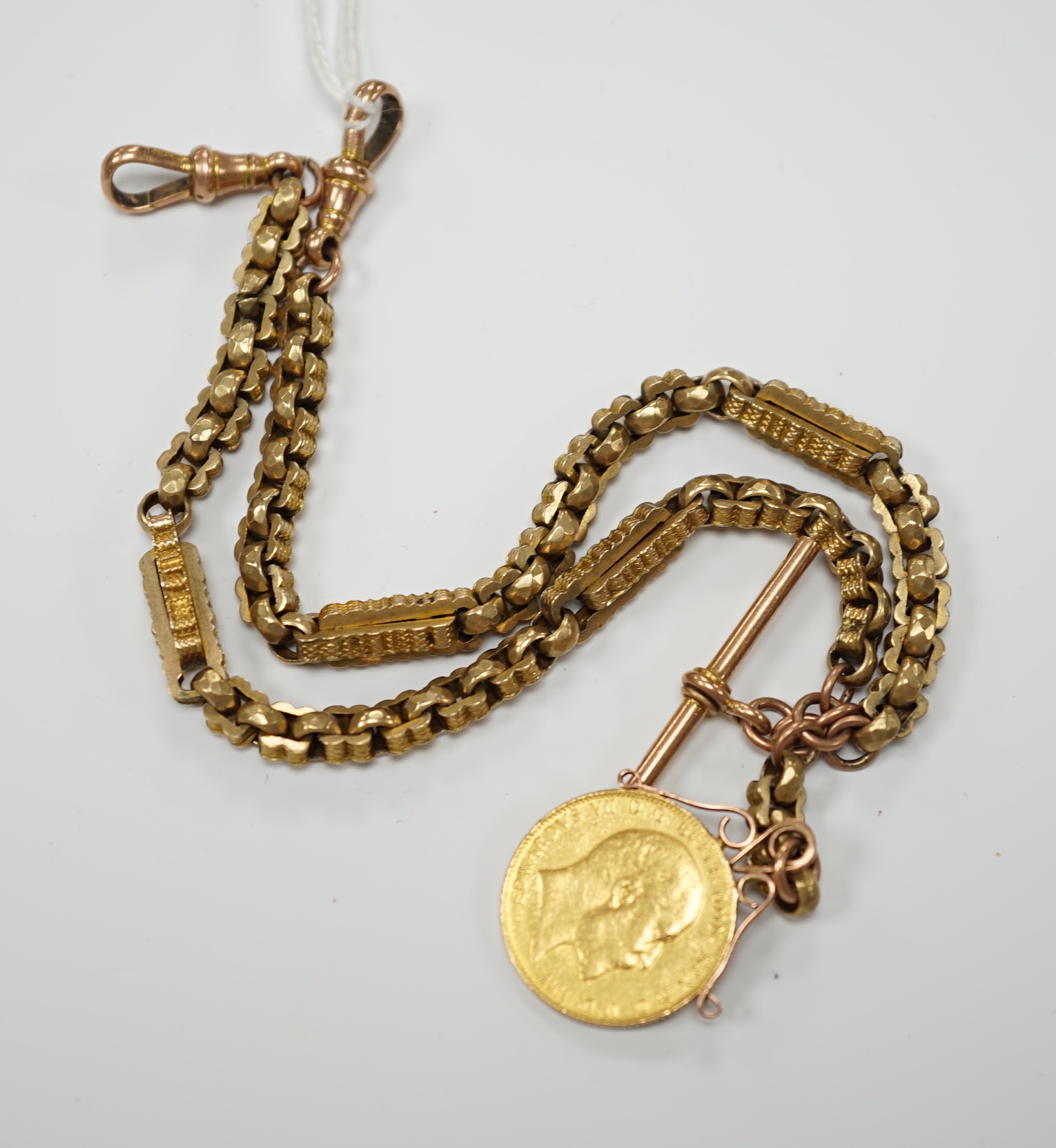 An Edwardian 9ct albertina, 34cm, hung with a Edward VII 1908 gold sovereign, gross weight 34.4 grams.